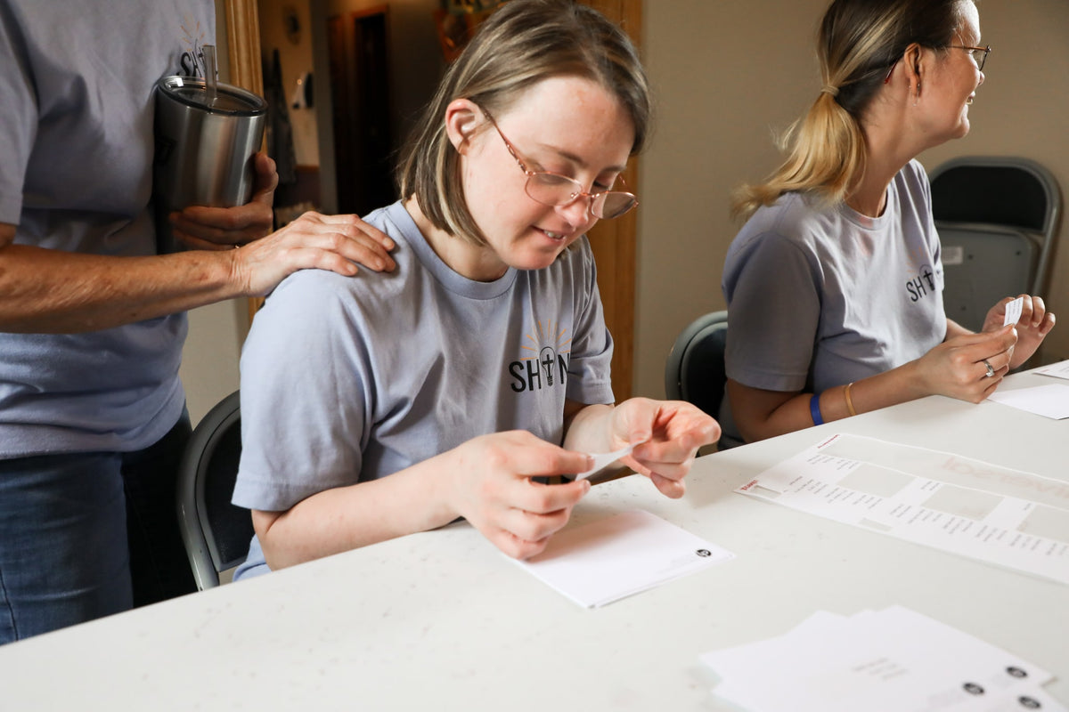 SHINE member working at a table
